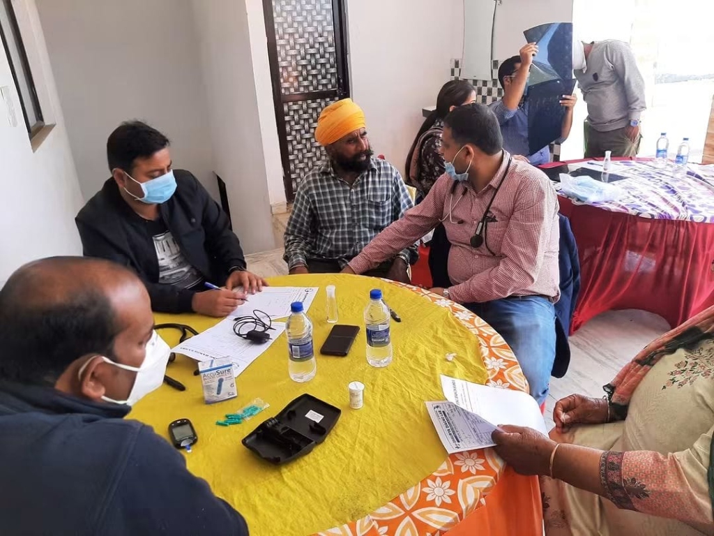 Volunteer doctors conducting free health checkups and blood pressure diagnostics