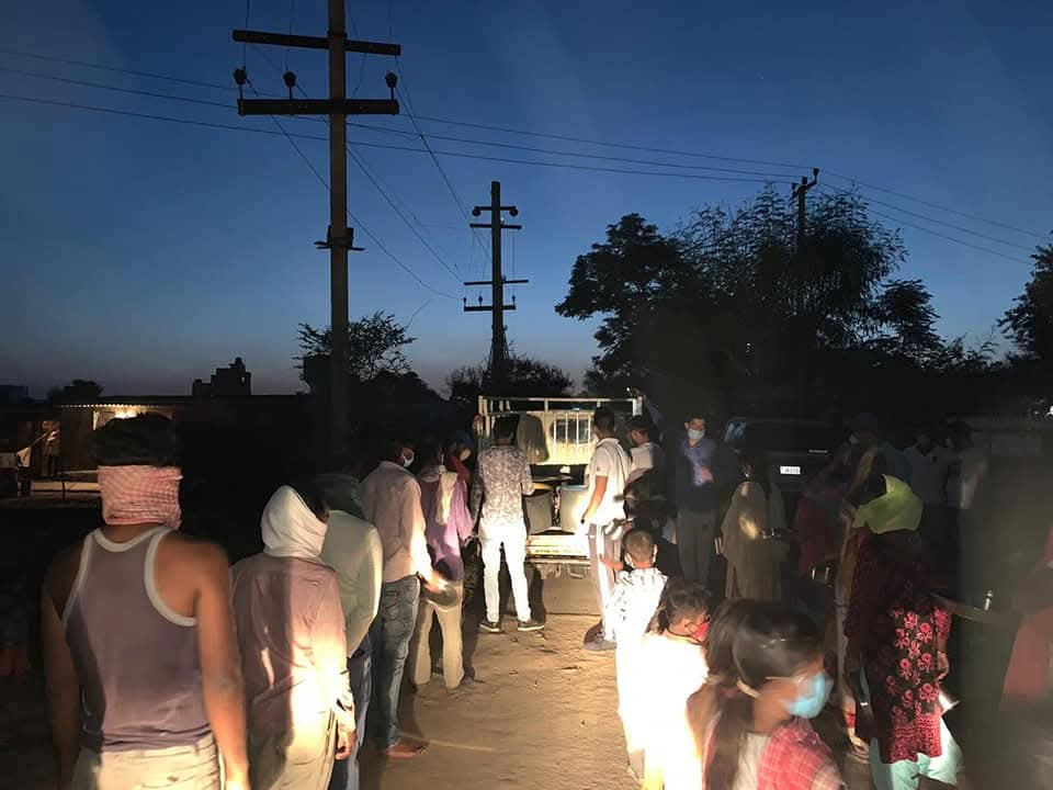 Volunteers distributing emergency rations during night relief drive