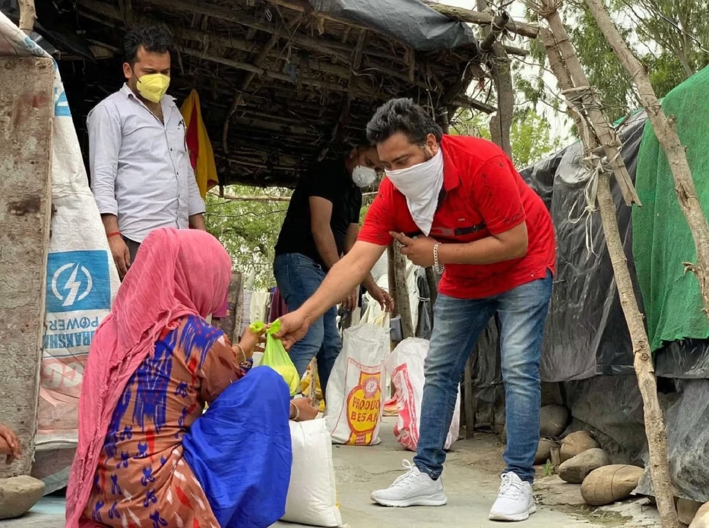 Foundation volunteers distributing essential relief rations and clothing directly to a village family in Jammu & Kashmir